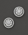 Diamond flower stud earrings framed in diamond pavé, set in 14 Kt. white gold.