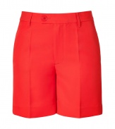 Stylish shorts in bright red synthetic fiber - Lean, slightly longer cut hits above the knee - Higher waisted, with belt loops, zip fly and button tab closure - Welt pockets at rear, slash pocket at sides - Crease detail flatters and elongates the silhouette - Casually elegant and versatile, easily dressed up or down - Pair with a blouse, denim jacket and flat sandals by day, or with a silk top, blazer and wedges at night