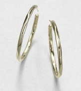 From the Glamazon Collection. Simple, sculptural hoops in subtly faceted gold are both modern and timeless.18k yellow goldDiameter, about 1.6Post backImported