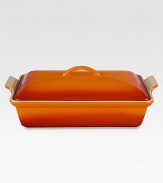 Crafted from heavy stoneware, Le Creuset cookware is the ultimate ingredient for chefs and home cooks worldwide. With its secure lid, this covered casserole is a convenient choice for transporting dishes to parties and picnics. Not only does the lid provide an effective moisture and heat lock for the dish, but it prevents spills and protects its contents.