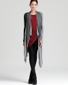 Layer your look with this draped Helmut Lang cardigan-long and luxurious in soft merino wool. Effortlessly cool over office separates, it brings edge to every style it meets.