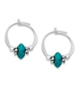 Petite hoop earrings with bright flecks of color. Jody Coyote's pretty style features simulated turquoise and silver beads set in sterling silver. Approximate diameter: 1/2 inch.