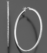 These slender hoops add the perfect touch of subtle glamour to your look. Featuring diamond accents set in sterling silver. Approximate diameter: 1-3/4 inches.