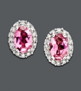 Express your femininity with pretty pink studs. Earrings feature a royalty-inspired look with oval-cut pink tourmaline (9/10 ct. t.w.) and a halo of round-cut diamonds (1/8 ct. t.w.) set in 14k white gold. Approximate diameter: 1/4 inch.