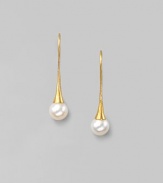 Delicate freshwater pearls dangle from hand-hammered 24k gold settings. 8mm white, round freshwater pearls 24k yellow gold Length, about 1¼ 22k gold ear wire Imported