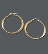 Add a little luxury to your look. Luminous gold hoops are an essential piece in every stylish woman's wardrobe. Earrings feature a unique oval design crafted in 14k gold. Approximate diameter: 1-1/2 inches.