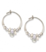 Prismatic shine. Jody Coyote's pretty hoop earrings feature iridescent Czech glass and silver accent beads, set in sterling silver. Approximate diameter: 1/2 inch.