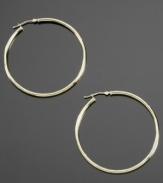 Smooth, sultry and stylish, these 14k gold hoop earrings always elevate your style. Approximate diameter: 1/2 inch.