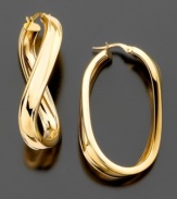 Lovely 14k gold oval hoop earrings spiced up with a twist. Length 2.