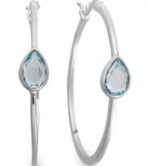 Traditional hoops with a sparkling pop of color. Victoria Townsend's glam style features pear-cut blue topaz (2-1/5 ct. t.w.) in a shining sterling silver setting. Approximate diameter: 1-1/2 inches.