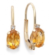 Sparkling perfection. Add a vibrant pop of color to your look with oval-cut citrine (3/4 ct. t.w.) and sparkling diamond accents. Crafted in a 14k gold leverback setting. Approximate drop: 3/4 inch.