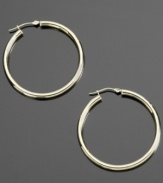 Gleaming appeal. These shining hoop earrings are crafted in 14k gold. Approximate diameter: 3/8 inch.