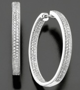 Glamorous hoop earrings complete with sparkling round-cut diamond (1 ct. t.w.) set in 14k gold. Approximate diameter: 1 inch.