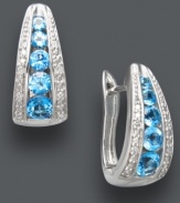 Traditional hoops in bold, blue hues. Classic J-hoop earrings receive a sparkling touch with round-cut blue topaz (1-1/2 ct. t.w.), round-cut diamonds (1/10 ct. t.w.), and a polished sterling silver setting. Approximate diameter: 1/2 inch.