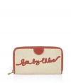 Add whimsical appeal to your everyday style with this chic logo wallet from See by Chloe - Classic rectangular shape, cotton with leather detailing, front logo script, zip-around style, billfold, card slots, and change purse - Great for everyday use or as a thoughtful gift