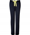 Detailed in super soft navy tumbled satin, Juicy Coutures neon trimmed pants are a sporty choice as comfy as they are chic - Neon lime grosgrain drawstring with gold-toned logo engraved aglets, logo charm, neon lime side trim, slit ankles - Loose fit - Wear with a tissue tee, hoodie and shearling lined boots