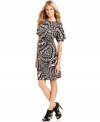 This statement-making dress from Calvin Klein features a bold tribal pattern and a soft, elegant drape. Stylish sandals add drama to the chic silhouette.