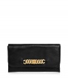 Elegant clutch made of soft, black leather in a classic, elongated shape - Features a traditional flap closure and  inside zipped pocket - Decorative gold-colored chain element creates chic, trendy look - Perfect for a posh cocktail dress, or jeans and heels for a night out downtown