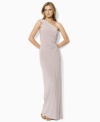 Rendered in slinky matte jersey, this glamorous Lauren by Ralph Lauren dress is elegantly designed in a sweeping one-shoulder maxi silhouette with shirring at the left bodice for a romantic appeal.