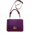 Luxury bag in fine ruby-colored calf leather with violet suede flap - Fashionable handbag shape is slightly curved with turn lock, short and long handles - Statement piece looks great with pants suits - Elegant for day or evening