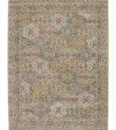 Imported from India, this magnificent rug presents a courtly style fit for today's most fashionable homes. Varying shades of green and beige are patterned in distinctive traditional design. Hand-tufted from ultra-soft 100% wool pile.