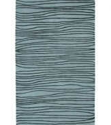 Presenting a new wave in fashionable home decor, this fluid area rug is streaked with black lines across a shimmering ocean-blue ground. Crafted from dense wool pile, the Artist Studio rug offers a uniquely textured feel that is incredibly soft to the touch.