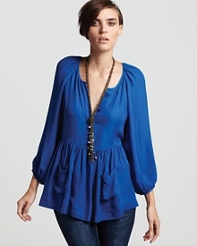 A lush French Connection top infuses your day with brilliant color and ladylike style, flaunting pleating at the shoulders and blouson sleeves--but it's the ruffled hem with patch pockets that steals the show.