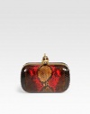 A luxurious fire python style with a skull accented closure.Top clasp closureLeather lining6¼W X 3½H X 1¼DMade in Italy