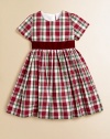 Adorned with a festive plaid print and velvet tie, this gorgeous cotton frock will make your little girl feel like a sugarplum fairy.ScoopneckShort sleevesBack buttonsWaistband with velvet ribbon tieFull skirtFully linedCottonDry cleanImported Please note: Number of buttons may vary depending on size ordered. 