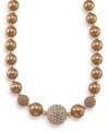 A vibrant gold graduated necklace is the perfect final touch. Created by Carolee, necklace features glass pearls and twinkling crystal fireballs. Crafted in 12k gold-plated mixed metal. Approximate length: 16 inches + 2-inch extender.