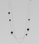 A long, delicate piece with beautiful round black agate stations on one of the two sterling silver link chains. Black agateSterling silverLength, about 39¾Clasp closureImported 