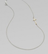 A simple, sleek cross of 14k gold sits sideways within a delicate sterling silver chain in this eloquent design.14k yellow gold and sterling silverLength, about 18Spring ring claspMade in USA