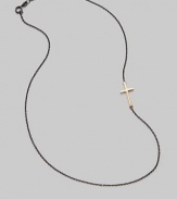 A gleaming 14K gold cross on an oxidized silver chain.14K gold Oxidized sterling silver Length, about 16 Pendant length, about ¾ Lobster clasp closure Made in USA 