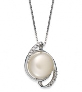 Capture a classic style. This sterling silver necklace suspends a cultured freshwater button pearl (11-12 mm) surrounded by swirls of diamonds for refined elegance. Approximate length: 18 inches. Approximate drop length: 3/4 inch. Approximate drop width: 1/2 inch.