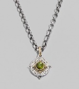 Chic little accent in gleaming sterling silver and 18k gold, centered with a smooth cabochon peridot stone. Chain sold separately About ½ diam Imported