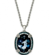 A piece of the ocean. This stunning pendant features an oval-cut London blue topaz (10-3/4 ct. t.w.) surrounded by halos of round-cut black diamonds (1/3 ct. t.w.) and white diamonds (1/3 ct. t. t.w.). Set in 14k white gold. Approximate length: 18 inches. Approximate drop: 1 inch.