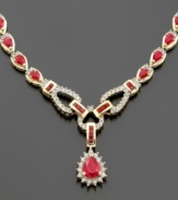 Blazing with the grand splendor of a stunning 12 ct. t.w. of rubies and 1 1/6 ct. t.w. of diamonds, this striking 14K gold toggle-style necklace will make any event a gala occasion. Prized for centuries as a symbol for royalty, the regal ruby is the birthstone for July.