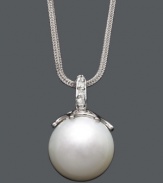 Highlight your neckline with a polished pearl and a hint of sparkle.  A single cultured South Sea pearl (14 mm) hangs from a delicate 14k white gold chain and bail accented with sparkling diamonds. Approximate length: 18 inches. Approximate drop: 1 inch.