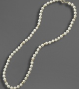 A dash of regal elegance, fit for the little lady. This simulated pearl necklace is studded with 14k gold beads and measures approximately 15 inches long.