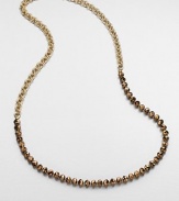 An artistic design with faceted beads on a double link chain. Glass beadsGoldtone brassLength, about 35Slip-on styleImported 