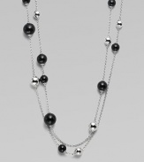 A very long, delicate piece with beautiful round black agate and contrasting sterling silver stations on a link chain, perfect for wearing doubled. Black agateSterling silverLength, about 51Clasp closureImported 