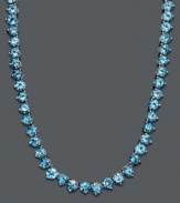 Cool down your look in icy blue hues. This vibrant necklace features a seamless row of round-cut blue topaz (45 ct. t.w.) set in sterling silver. Approximate length: 17 inches.