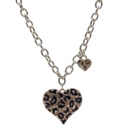 Become one with the animal kingdom. This wild style by GUESS features a leopard print heart pendant with black enamel and crystal accents. Crafted in gold tone mixed metal. Approximate length: 16 inches. Approximate drop: 1-1/2 inches.