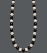 Show your true stripes with stylish, contrasting colors. Necklace features a chic strand of bold onyx beads (85 ct. t.w.) and cultured freshwater pearls (8-9 mm). Clasp crafted in 14k gold. Approximate length: 18 inches.