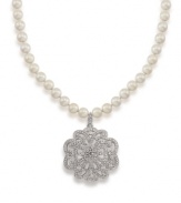 A glamorous floral pendant features a glittering array of crystals on this necklace from Carolee. Crafted with glass pearls and set in silver tone mixed metal. Approximate length: 18 inches + 2-inch extender. Approximate drop: 2 inches.