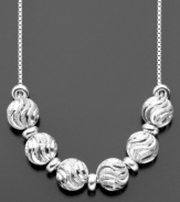 Exquisite waves light up these gorgeous beads (1/2 inch) of diamond-cut sterling silver. Necklace by Giani Bernini. Approximate length: 16 inches. Approximate drop: 2-1/2 inches.