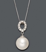 A traditional pearl pendant with an intricate touch. Belle de Mer necklace highlights a cultured freshwater pearl drop (9-10 mm) suspended from an oval-shaped, cut-out bail decorated in sparkling diamonds (1/5 ct. t.w.). Setting and chain crafted in 14k white gold. Approximate length: 18 inches. Approximate drop: 3/4 inch.