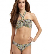 THE LOOKAbstract animal printAdjustable halter straps tie at neckBands crisscross at center with V-shaped openingPadded cups and side boningBack clasp closureTHE MATERIAL80% nylon/20% spandexFully linedCARE & ORIGINHand washImportedPlease note: Bikini bottom sold separately. 