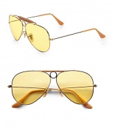 A vivid update to the classic aviator style, crafted in sleek, sophisticated metal and acetate with prominent top bar. Available in gold with ambermatic lens.Metal temples100% UV protectionMade in Italy