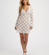 A crochet coverup that is beyond gorgeous.V-neckLong sleevesPull-on stylePolyesterDry cleanMade in USA of imported fabric